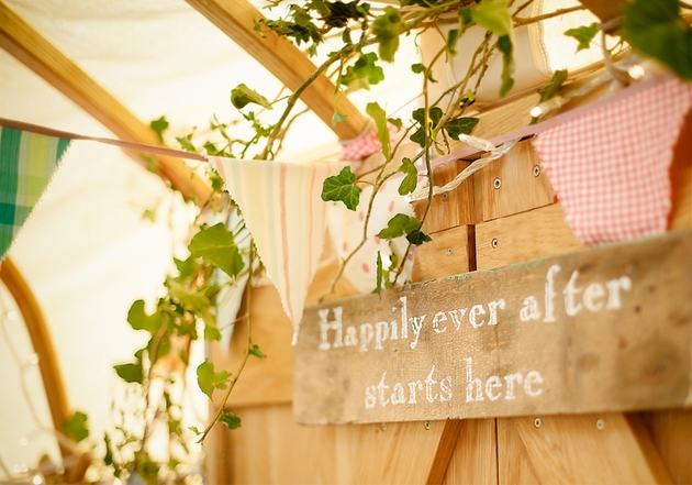 Door into wedding yurt with sign reading happily ever after