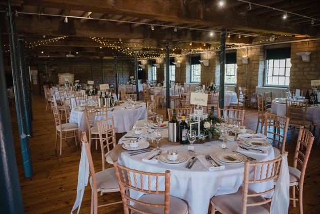 Interior of quirky Yorkshire wedding venue Standedge Tunnel with wedding table set up and fairy lights