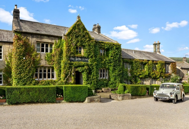 Exterior shot of wedding venue The Yorke Arms in Nidderdale with classic wedding car