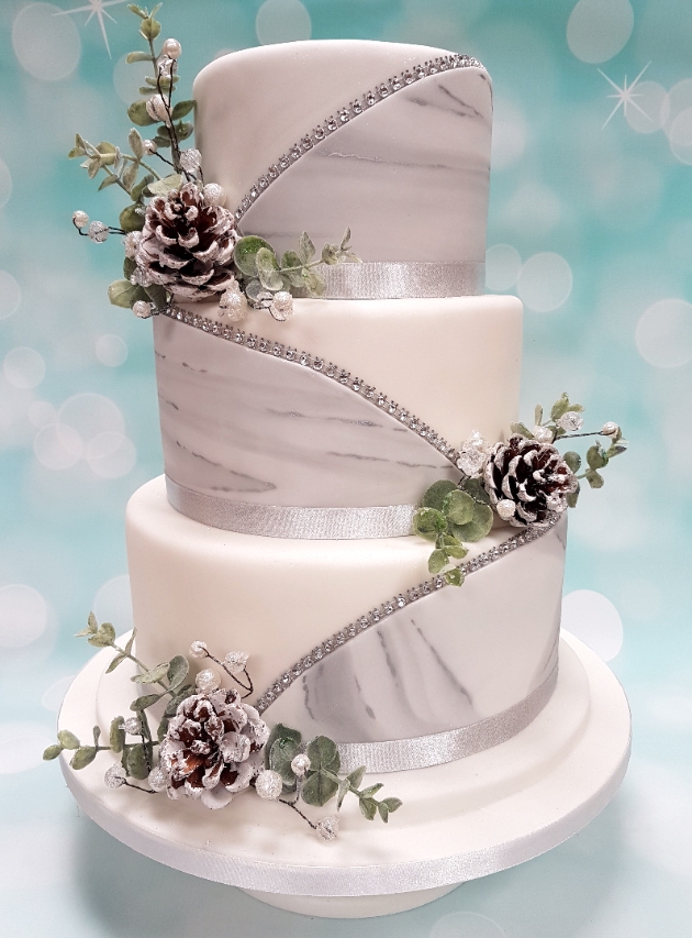 Christmas themed wedding cake in white icing and silver diamanté's by Cakes To Please in Bradford