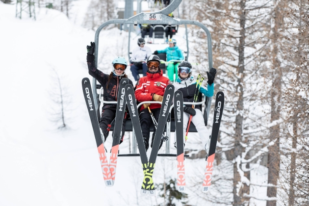 three skiers on a ski lift