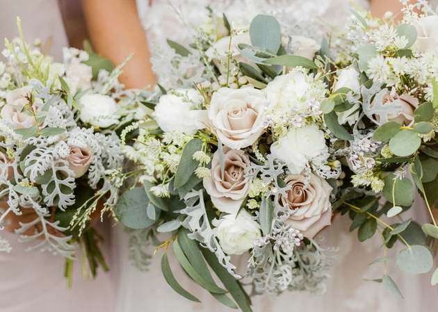 Bride and bridesmaids holding winter wedding bouquets