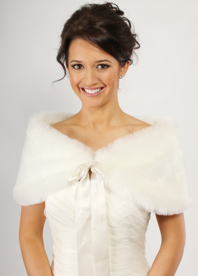 Brunette bride in wedding dress with ivory faux fur wrap by Richard Designs
