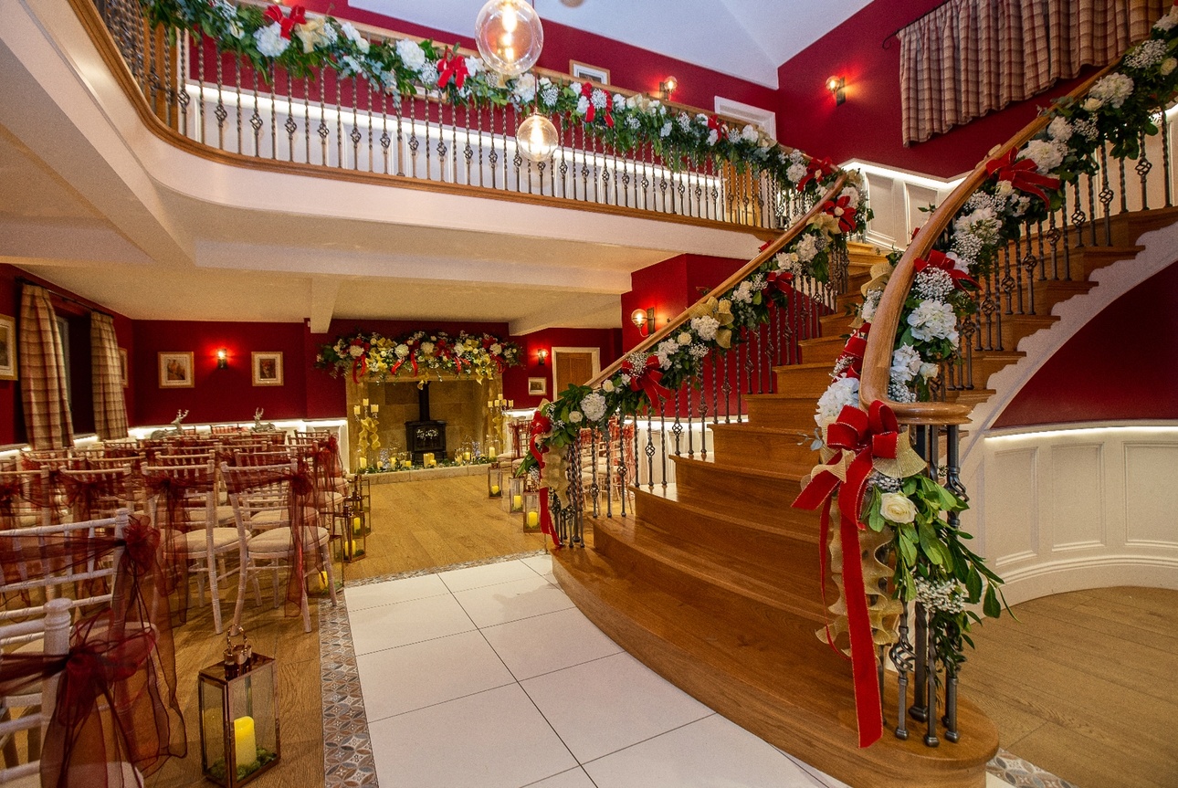 Interior of Yorkshire wedding venue Spicer Manor with staircase and fireplace decorated for Christmas