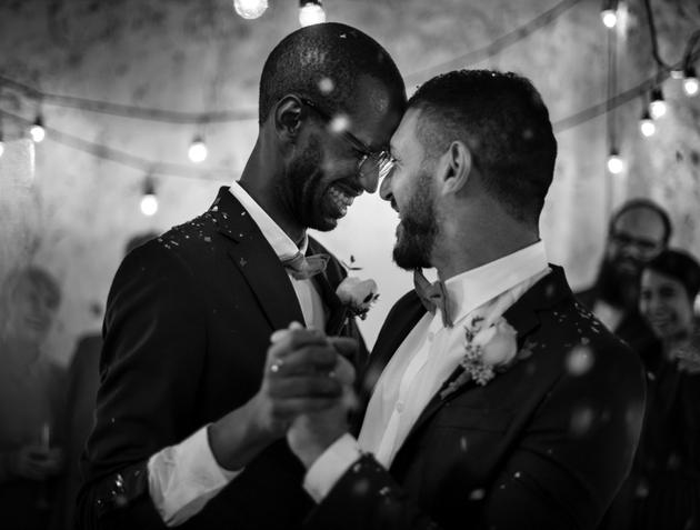 Black and white image of newlywed couple having their first dance.
