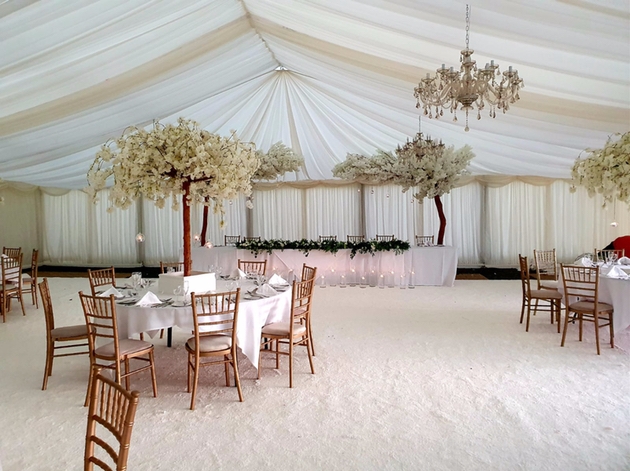 Interior of marquee with raping and blossom trees at Holiday Inn Leeds Bradford