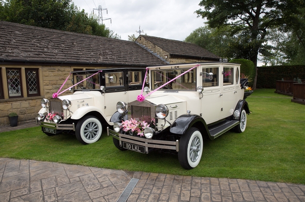 Two classic wedding cars outside a wedding venue in Yorkshire