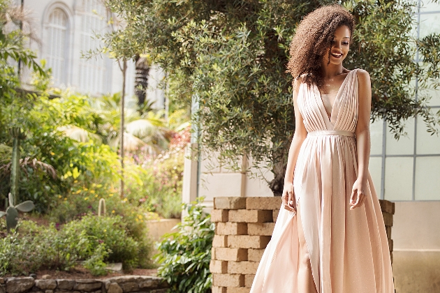 Bride wearing blush dress and hair swept to one side