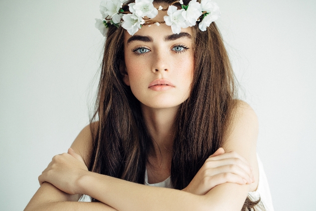 Bride wearing white flower crown and natural looking makeup