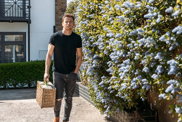 Joe walking with a hamper