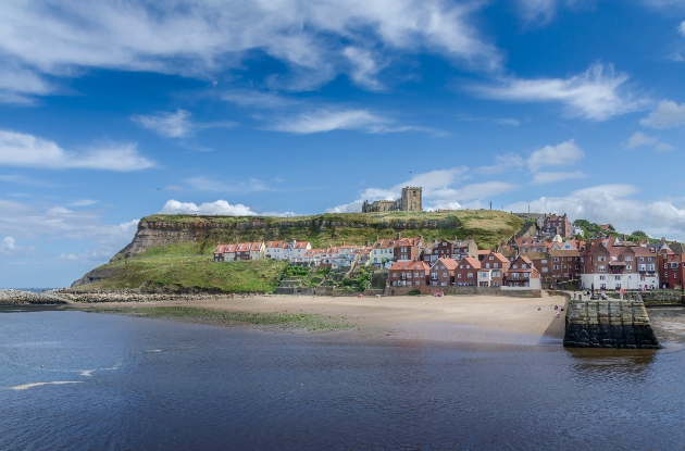 coastline cliffs and castle blue skies