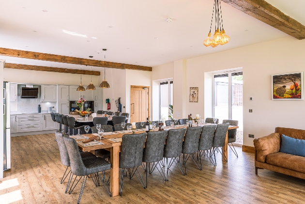 white walls exposed beams large dining table