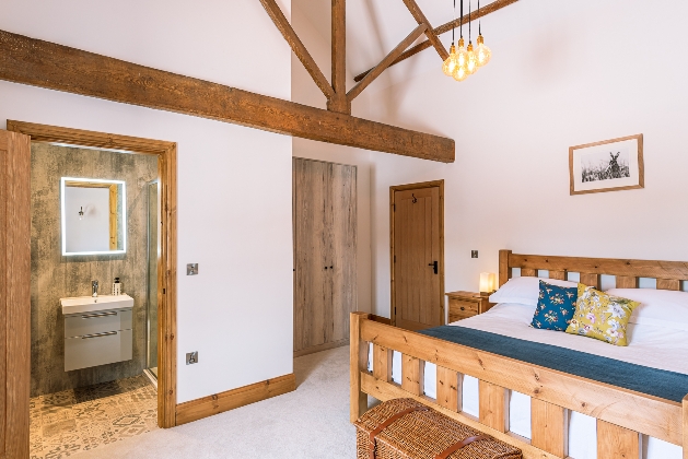 white walls exposed beams wooden bed