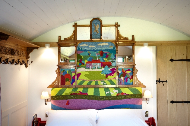 headboard with coloured folksy scene painted on