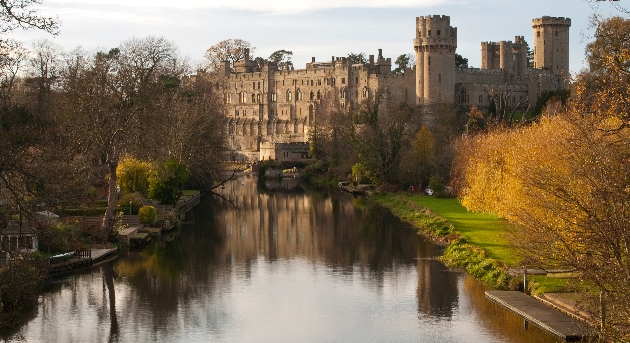 castle with a moat and bridge on an autumn day