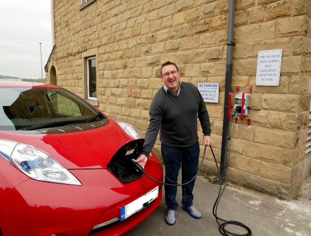 Man plugging in electric car