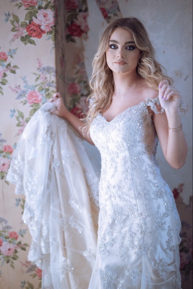 bride with long wavy blonde hair looking at camera