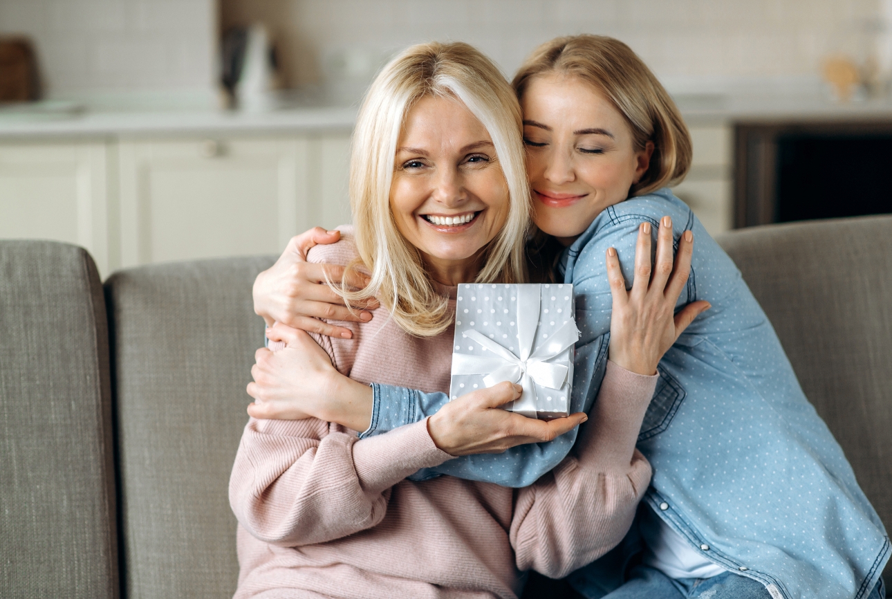 daughter hugging mum on the sofa