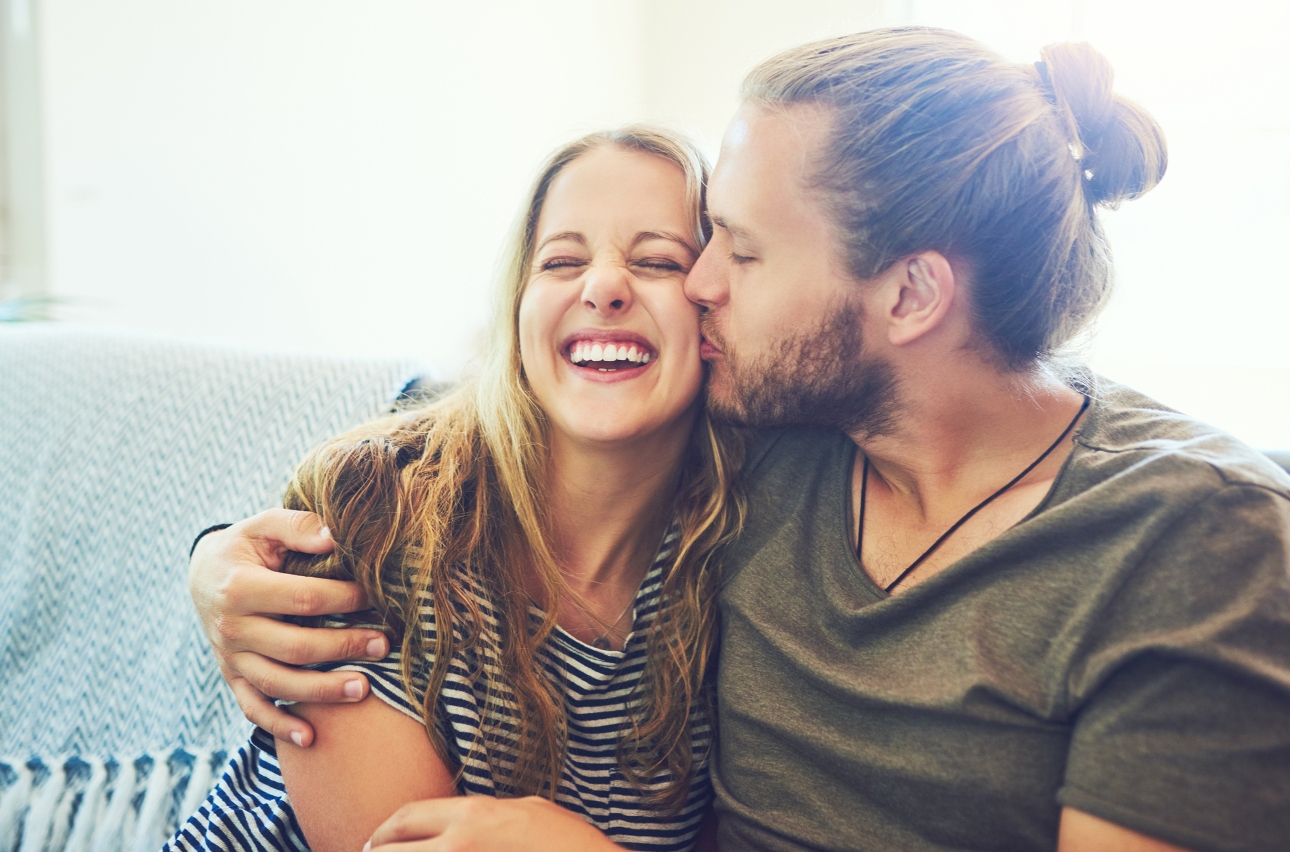 couple snuggled on a sofa