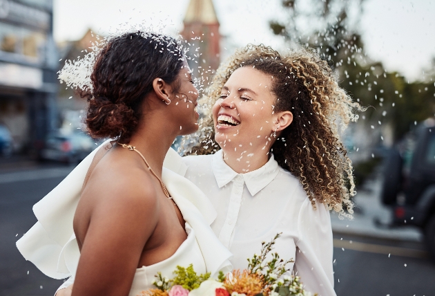 two brides embraced in the street