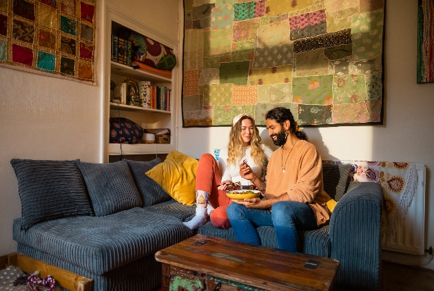 couple on a sofa eating dinner