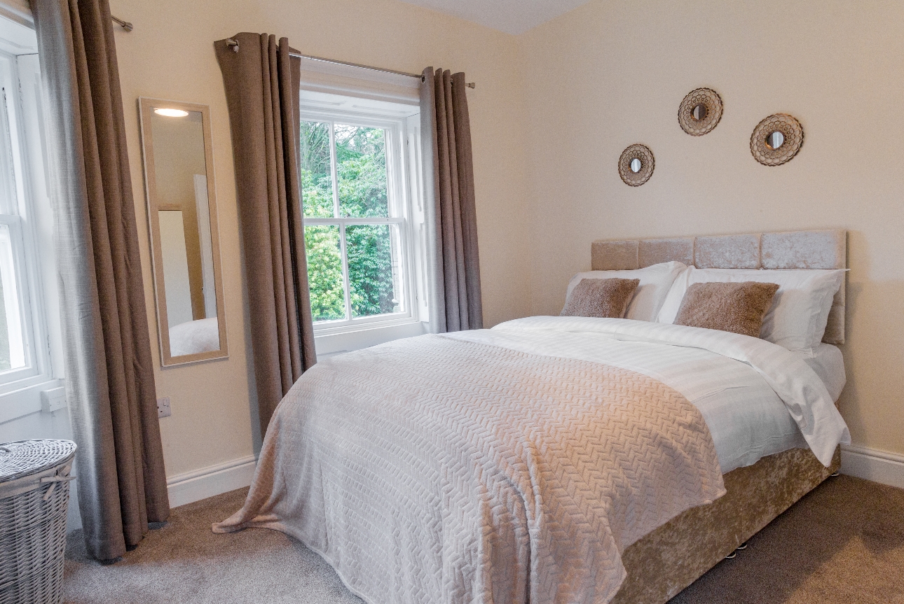 double bedroom with bed decorated in neutral tones