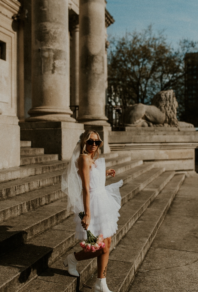 bride looking at camera with sunglasses on