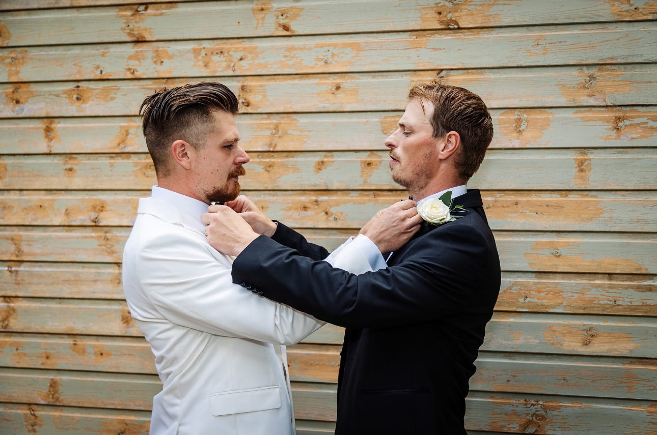 Groom and best man fixing ties