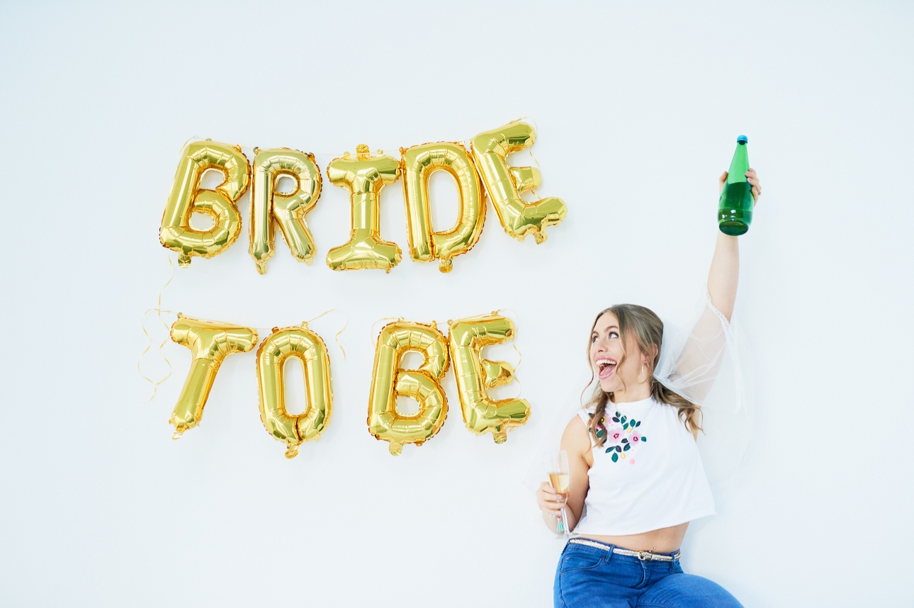 bride in front of bride to be balloons with a veil on