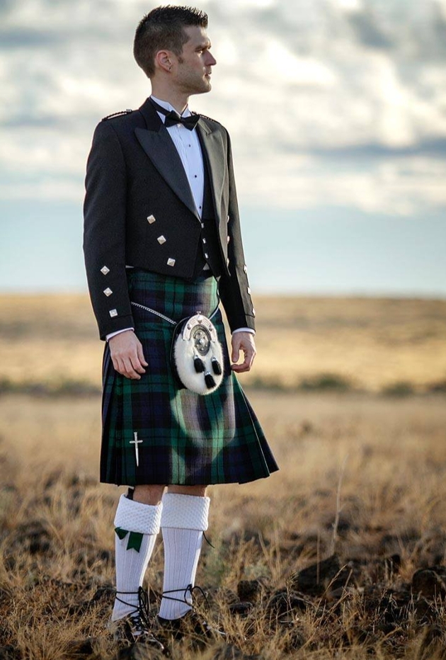 model in a green tartan kilt with full traditional accessories