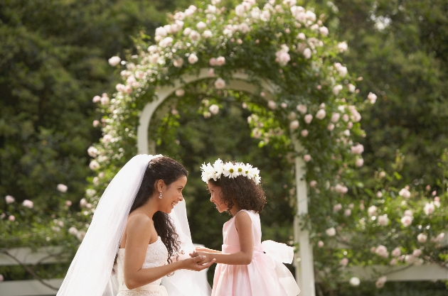 bride bent down to her bridesmaid wearing floral crown