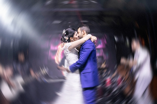 couple kissing on wedding dancefloor