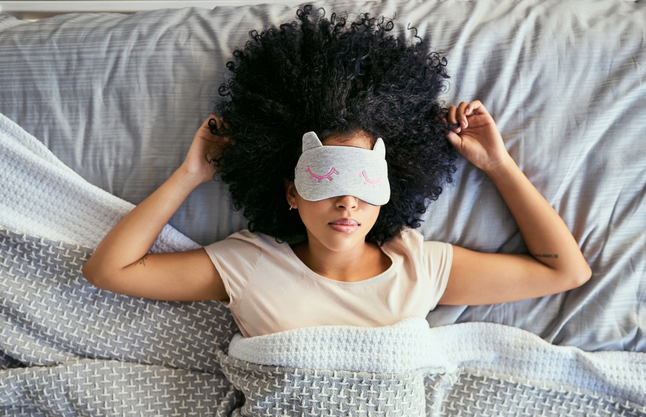 woman asleep in bed with eye mask on