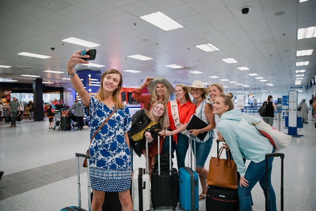 group of women at the airport taking a selfie