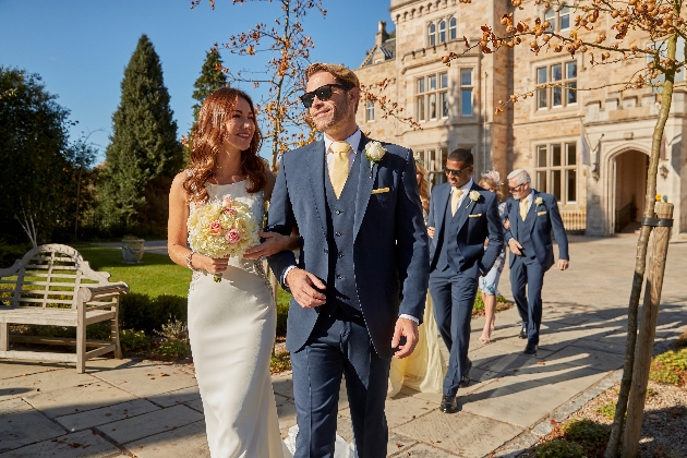 Couple walking with their wedding party