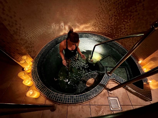 Woman in swimsuit Embracing Cold Therapy in spa pool