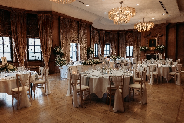 The Grand's dining room set for a wedding with chandeliers