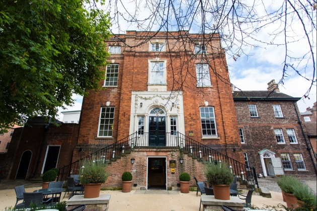 exterior of York townhouse with small bistro tables outside