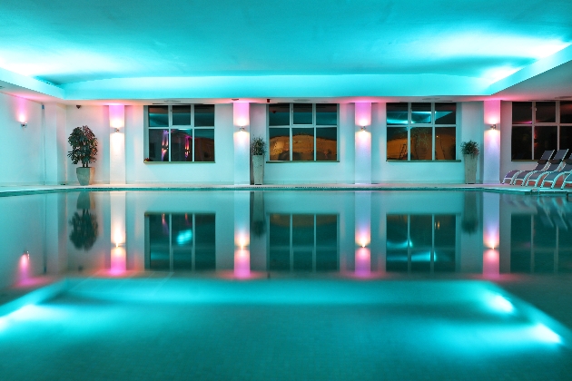 pool at a spa lit with pink and blue lights