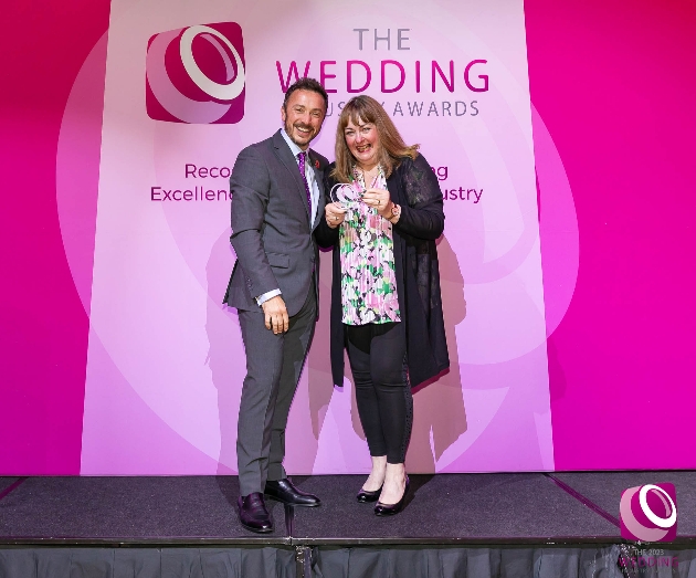 kerensa dyson holding bridal award on pink stage