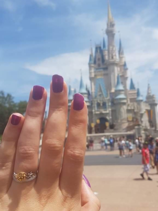 Chloe wearing ring in front of Disney castle