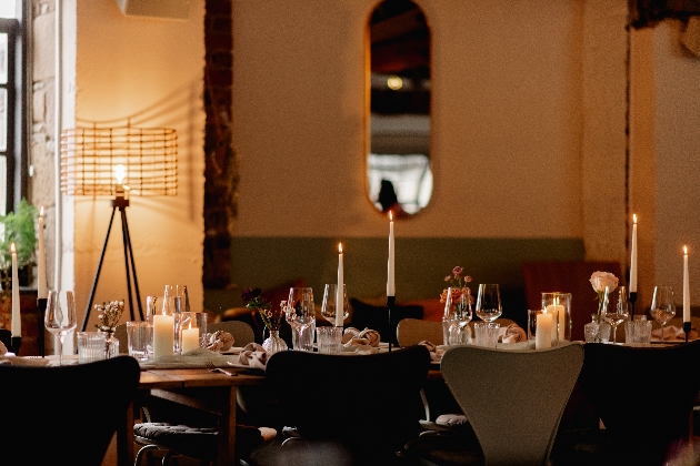 room with table set up for a wedding and candle light