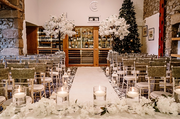 The Coniston Hotel's ceremony room, white aisle, chivari chairs, wine storage