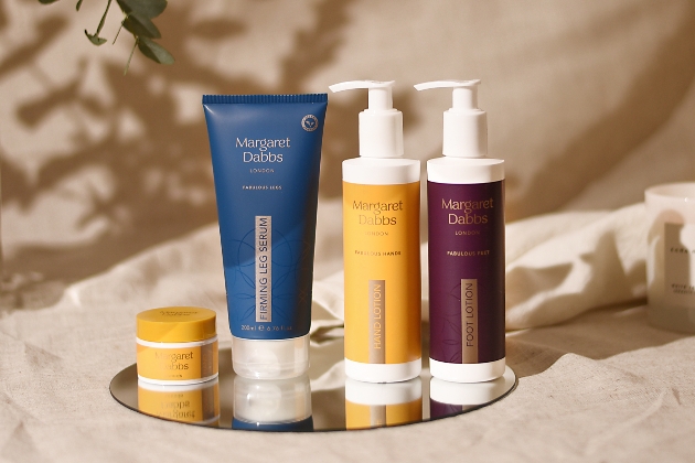 Margaret Dabbs products in blue, yellow and aubergine packaging. 