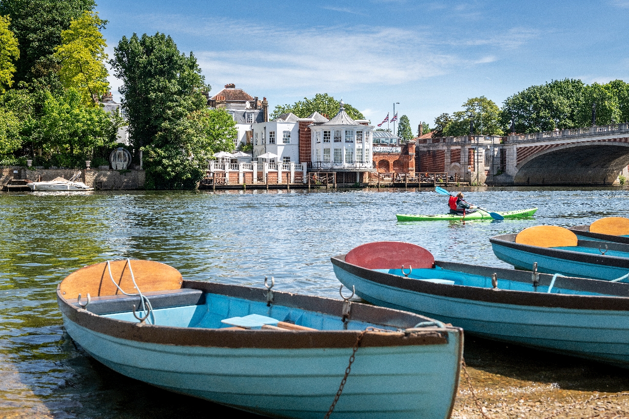 view of hotel, from across the river, river boats in water