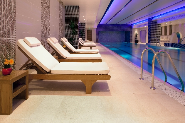 two loungers next to a pool indoors