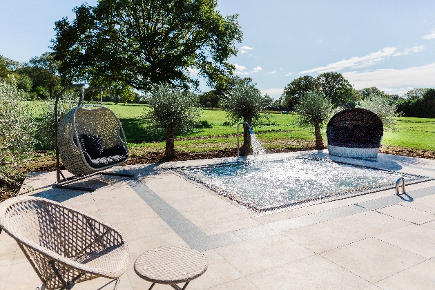 outdoor jacuzzi wicker hanging chairs round it