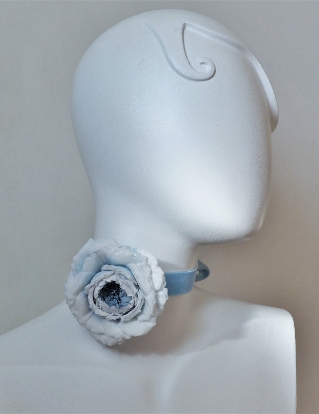 large blue flower rosette on a mannequin head