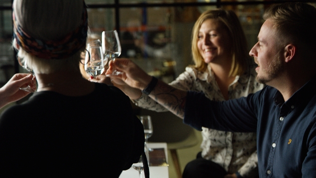 group of people toasting with glasses