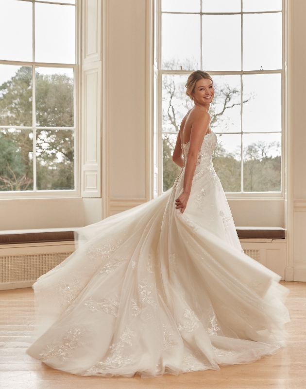 model in wedding dress cream colour lace details strapless 